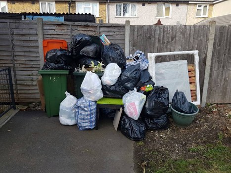 Waste collection truck operating in East London streets